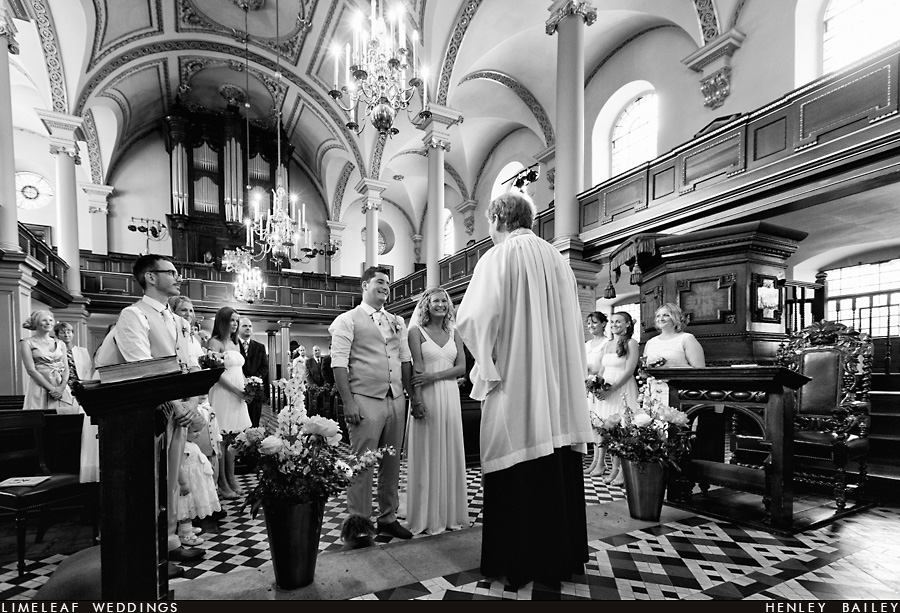 Bride and groom are seen at the altar at St Giles in the fields church in Soho, London during their wedding ceremony