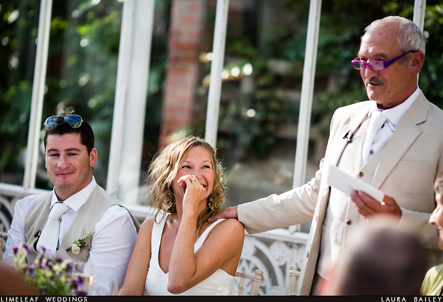 Bride laughs as her dad does his wedding speech