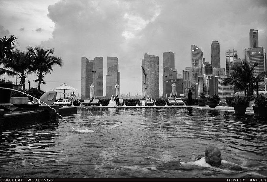 Newly married couple relax on the sunloungers by the pool at The Mandarin Oriental Hotel in Singapore