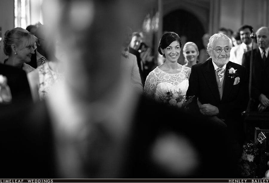 Bride walks down the aisle at Payhembury Church for her wedding ceremony