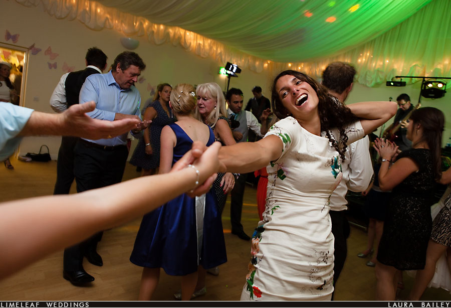 wedding guests dance at evening wedding reception in Payhembury, Devon